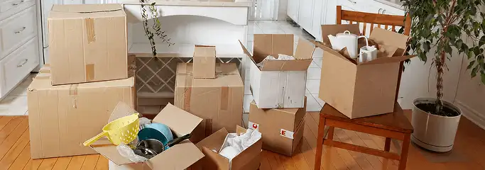 Packed moving boxes and household items in a kitchen before move-out or move-in cleaning, Philadelphia, PA.